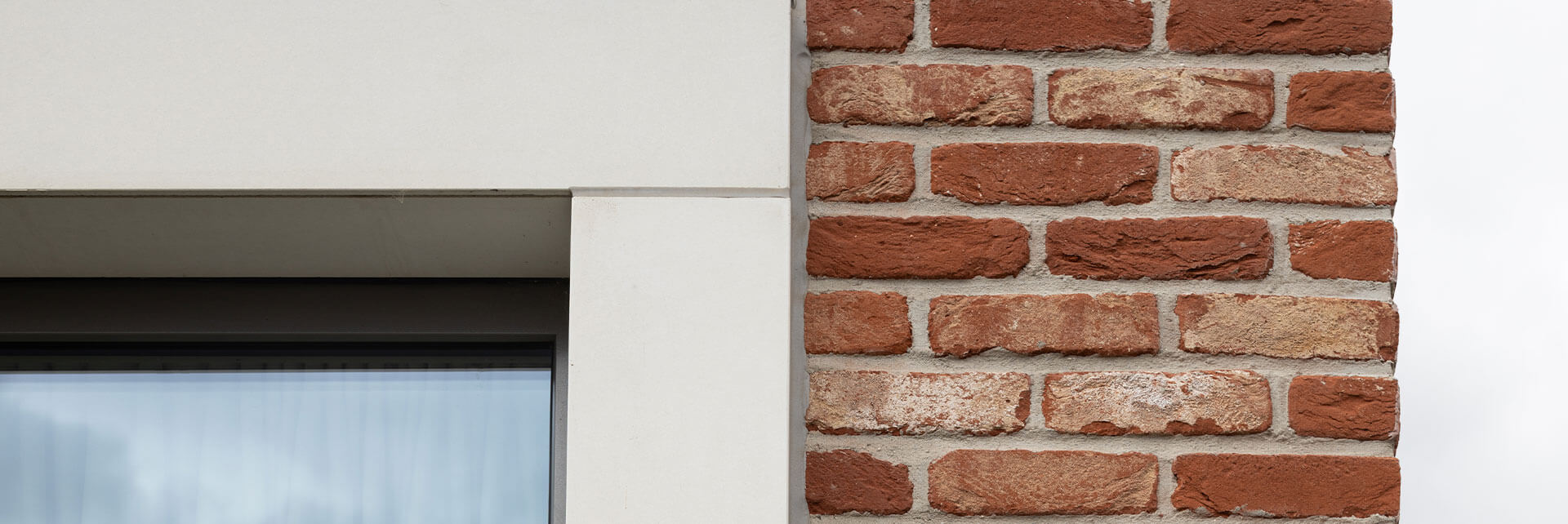 Nahaufnahme der WDVS-Fassade des Kindergartenneubaus in Ralbitz-Rosenthal mit Klinker, Faserbeton und modernen Fenstern.